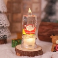 Nahaufnahme der beleuchteten LED Weihnachtskerze mit Weihnachtsmann und Glitzereffekt - Rucksack Weihnachtsmann