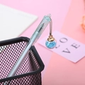 Light blue aesthetic gel pen with a star-filled glass ball pendant in a mesh pen holder - Blue Wish Bottle