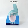 Detailed close-up of blue gradient knitted handbag with pink tulip floral embroidery - Blue Flower