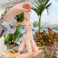 Detailed view of a pink plush alpaca keychain with a golden clasp on a bag - Gold Clasp / Pink