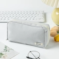 Close-up of light grey canvas pencil case with zipper and label on a desk setup - Light Gray