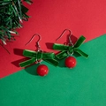 Christmas earrings with green velvet bows and red pom-poms on a festive background - Green Velvet Bow Red Ball