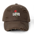 Close-up of distressed brown baseball cap with embroidered rose and LOVE lettering - One Size / Coffee