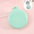 Portable folding hairbrush in mint green with integrated mirror and white air cushion - Simple Green Cushion Brush