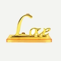 Scritta 'Love' dorata su base trasparente, variante romantica rosa in foglia d'oro - Base LOVE Singola