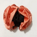 Elegant peach pink fabric rose hair clip with satin texture and black banana claw grip - Dusty Pink