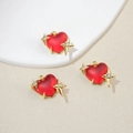 Macro detail of red frosted heart pendant with gold star and white zircon inlay - Red