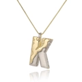 Detailed shot of two-tone letter K pendant with irregular texture on gold chain - Letter K