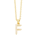 Macro shot of gold letter F pendant with inlaid white pearls on an elegant O-chain necklace - Gold Letter F