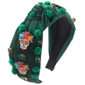 Detailed macro view of dark green velvet headband with skulls and resin roses - Green
