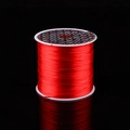 Red elastic stretch string for jewelry making on a professional black background - Red