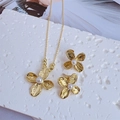 Gold floral jewelry set with brushed metal petals and pearls on a sleek necklace and earrings - Set