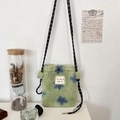Detail of plush green crossbody bag with blue floral pattern and woven strap - Green Paisley Sunflower