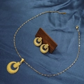 Close-up of matte gold geometric jewelry set with round necklace and earrings on silk - E6107-8/Gold Frosted Round Buckle