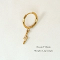 Detailed close-up of a gold lightning bolt hoop earring with white cubic zirconia stones - Pave Zircon Lightning