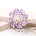 Detailed view of flower-shaped brooch featuring purple marquise crystals and white pearls - Purple