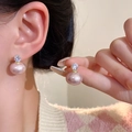 Pink pearl and zircon stud earrings with gold plating shown on a model's ear - Gold Pink Pearl Zirconia