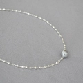 Macro detail of faceted gold beads and white pearl on minimalist brass choker necklace - Silver Plated + Grey Faux Pearl