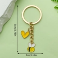 Golden heart keychain with yellow bee pendant and dimensions of 7cm length and 3cm width - Yellow Heart Bee