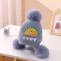 Blue knitted baby hat with three fluffy pom-poms and cute cartoon embroidery - Triple Pompom Dinosaur Ear Flap Blue