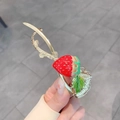 Close-up of strawberry hair clip with red enamel and gold-tone metal floral details - Enamel Strawberry Shape Gold Hair Clip