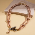 Detail of double-layer champagne pearl necklace featuring a sparkling crystal butterfly pendant - Double Layer Pearl Butterfly Necklace (WE5674) / Champagne/Coffee