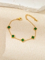 Detail view of gold star bracelet featuring green emerald zircons and lobster clasp closure - Emerald Square Zirconia (TYGB0022)