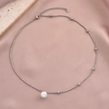 Elegant silver stainless steel pearl pendant necklace on soft pink silk fabric texture - Round Pearl Pendant