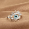 Silver evil eye open ring with blue and black gemstones on warm brown satin - Evil Eye Eyelash Trim (Q-J077) / White Gold