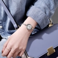 Silver bangle watch for women worn with denim jacket and light blue handbag - JSK Roman Numerals Silver Band White Dial