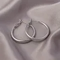 Polished silver minimalist hoop earrings displayed on elegant grey satin fabric background - Minimalist Hoop Style (E-023) / 50mm / Platinum