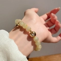 Elegant beaded bracelet with pale yellow opal stones and golden hollow ball pendant - Yellow