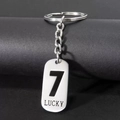 Detail of silver stainless steel keychain featuring Lucky 7 engraving and polished metal ring - Number 7