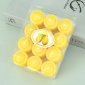 Detailed view of 12-pack lemon scented yellow tealight candles in clear box packaging - Yellow
