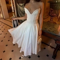Detail of white satin dress featuring corset boning and elegant pleated maxi skirt - XS / White