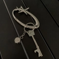 Silver metal oval keychain with star carabiner, dice charm, and key-shaped bottle opener - Star Oval Ring + Key Opener + Dice