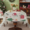 Christmas tablecloth with reindeer and holiday prints featuring elegant edge tassels - Christmas Teacup + Tassel