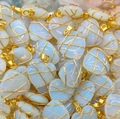 Bulk stack of moonstone heart pendants with golden wire wrap and opalescent blue sheen - Natural Opalite