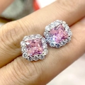 Pink square-cut zircon stud earrings with silver-tone halo setting held in hand - Pink Diamond Sugar Cube Earrings Led-85