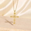 Close-up of golden cross necklace with zircons and X-shaped wrap on silk background - Style F-Wrap Cross