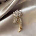 Macro shot of gold-plated flower brooch with marquise-cut crystals on silk background - 393# Lotus