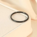 Polished black stainless steel thin band ring on a minimalist jewelry display stand - Size 5 / Black Interior and Exterior Round Band