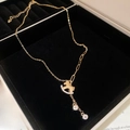 Detail of gold-plated rocking horse necklace with micro-pave crystals in a velvet box - Necklace - Gold