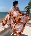 Detail showing oversized floral print beach shawl with fringe edges on balcony - Orange Brown Peony (Daisy-4)