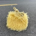 Detailed view of yellow faux sheepskin fur texture and PU drawstring on the bucket bag - Light Mustard Yellow