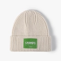 Oatmeal beige knitted beanie with green plaid woven patch and ribbed texture - One Size / Off White