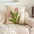 Luxury tulip floral embroidery cushion cover in cream white on a cozy beige sofa - Pink Tulip