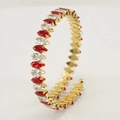 Detail view of gold stainless steel bangle with red and clear marquise-cut stones - Clear and Red