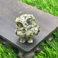 Hand-carved 3.5cm dalmatian jasper owl figurine placed on a dark wooden display base - Dalmatian Jasper