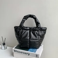 Minimalist black quilted down handbag with a puffy handle in a premium glossy finish - Black